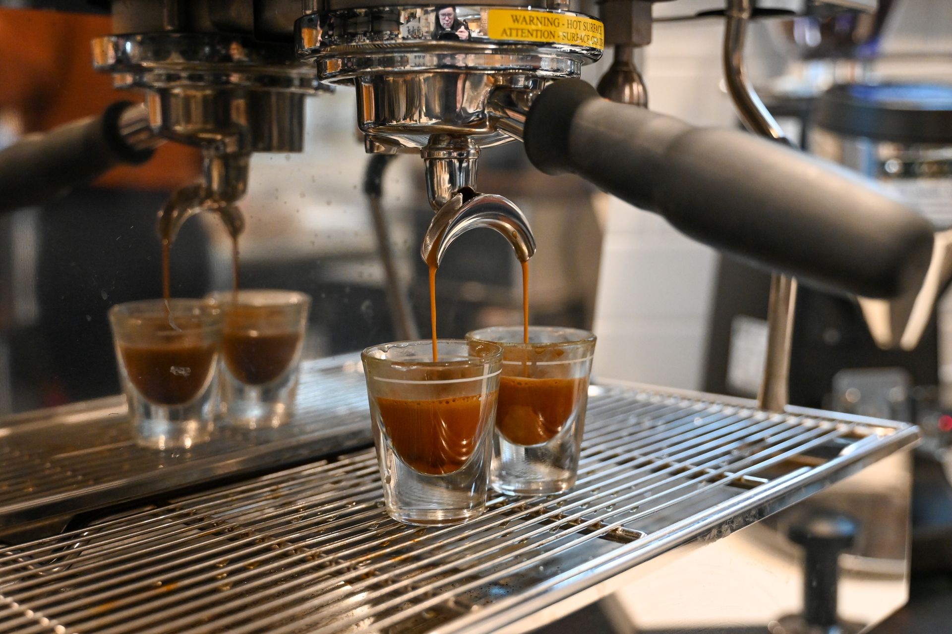 Two espresso shots pulling into glasses
